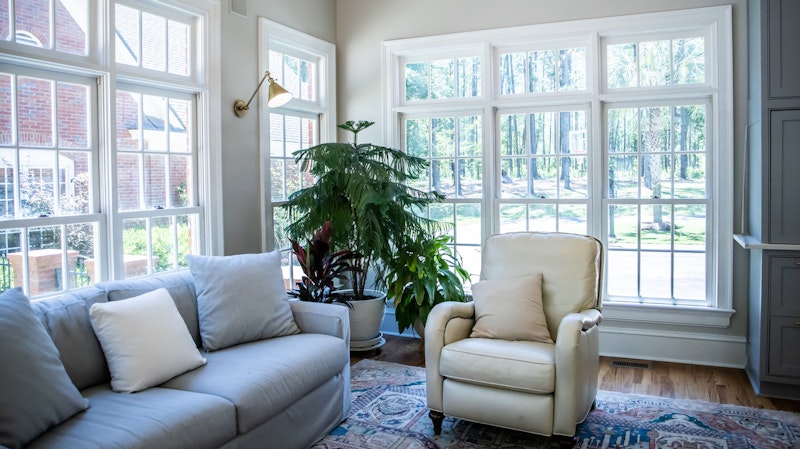 Living room with traditional style windows. Photo from Adobe Stock.
