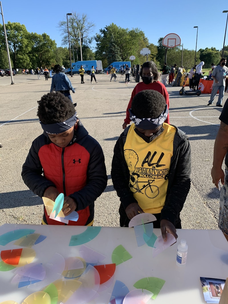 Children play with an interactive activity at a popup event.