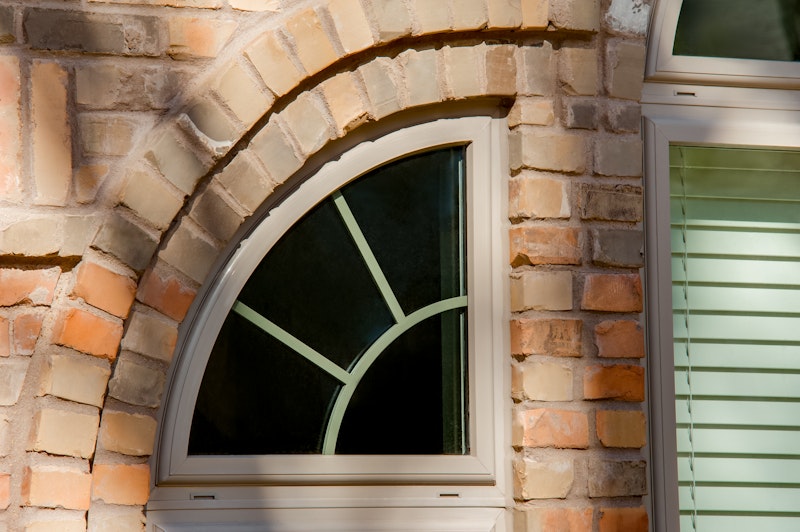 Close-up of quarter round picture window with grids.