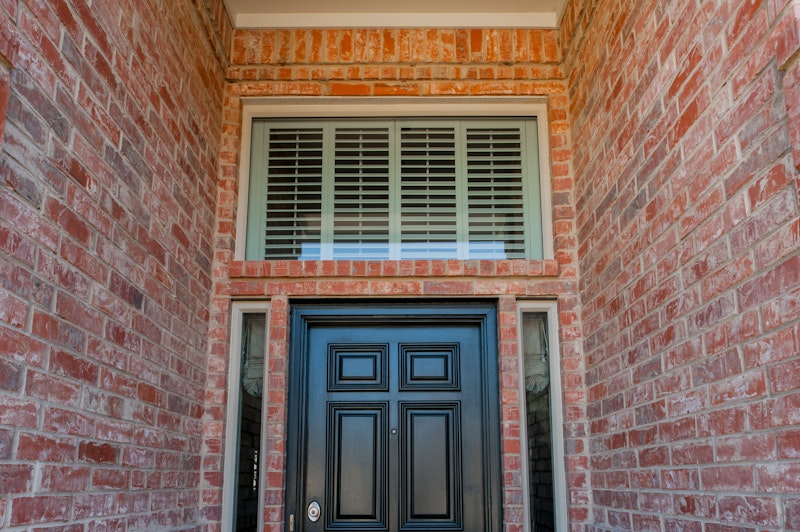 Close-up of large picture window over the door and slim sidelites.