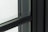 Close-up of contemporary grids on Andersen 100 Series black Fibrex casement window.