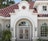 Exterior view of white Jeld-Wen Premium Vinyl Half Round Specialty Windows and grids above ornate white double entry doors.