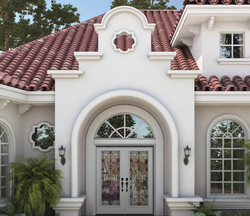 Exterior view of white Jeld-Wen Premium Vinyl Half Round Specialty Windows and grids above ornate white double entry doors.