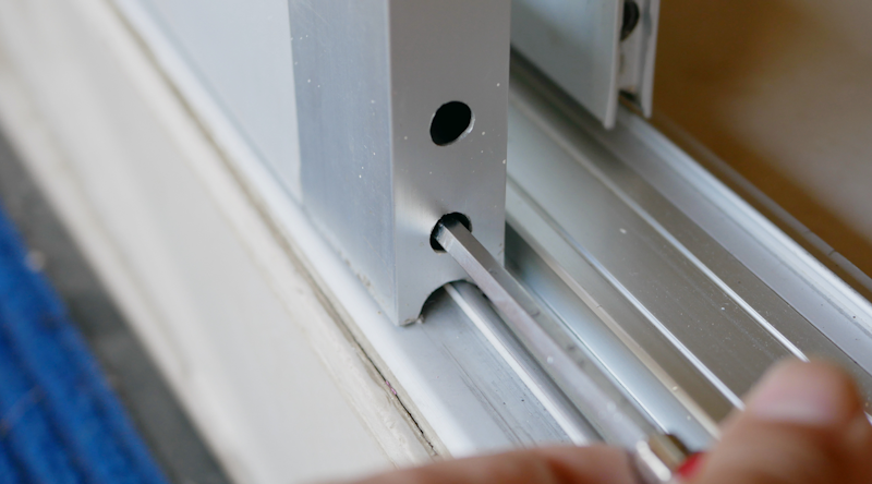 Adjusting sliding door panel and roller height. Photo from Adobe Stock.